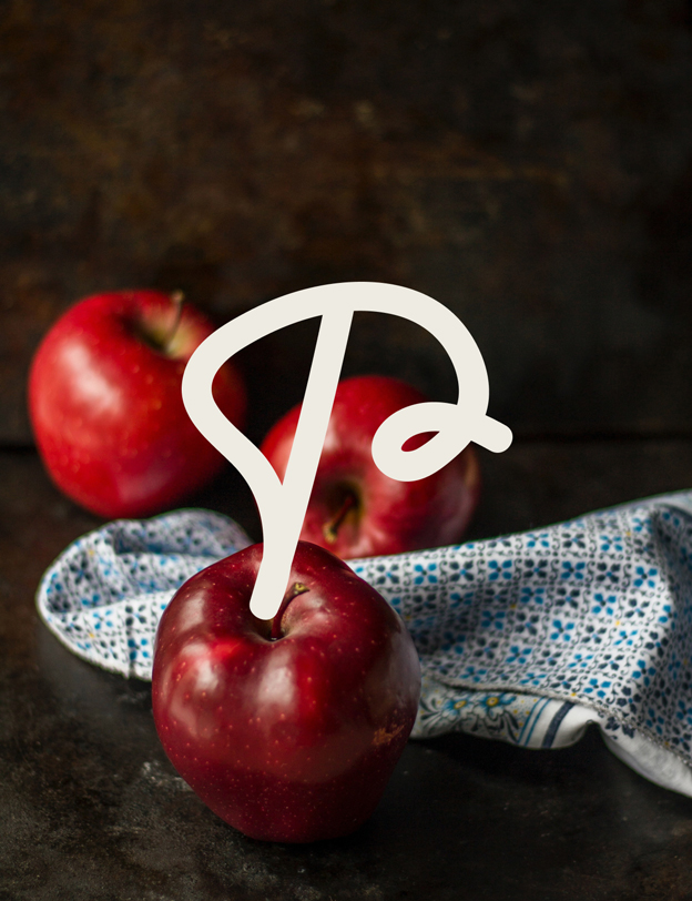 Icône P sur une photo de pommes.